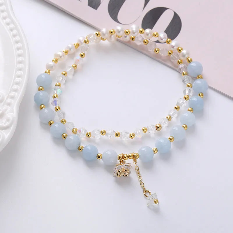 Handmade crystal double ring bracelet with natural freshwater pearl in strawberry quartz colour on wrist