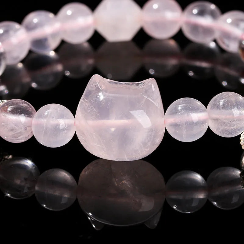 Natural star pink crystal cat head bracelet on a woman's wrist