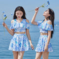 Women's one-piece swimsuit with fresh blue floral print on polyester fabric for summer swimming