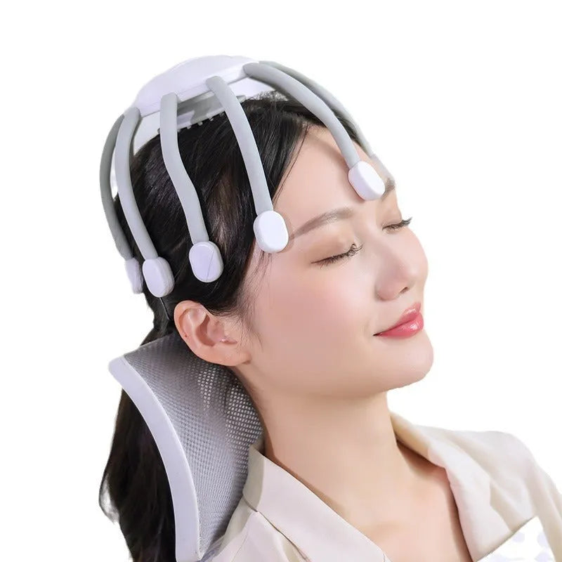 Black handheld electric scalp massager with multiple flexible silicone claws vibrating on a scalp.