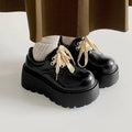 Matte black women's low-top shoes with a chunky 6-8cm heel and thick rubber sole on a white background.
