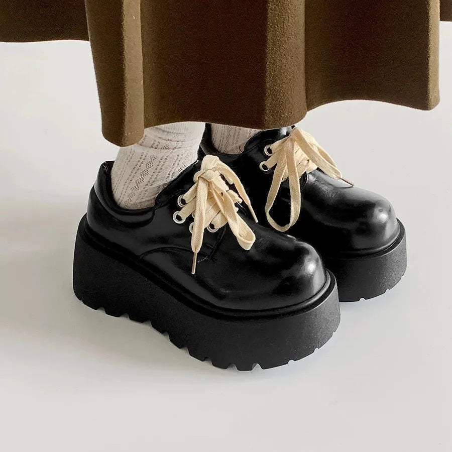 Matte black women's low-top shoes with a chunky 6-8cm heel and thick rubber sole on a white background.