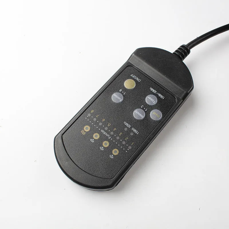 Black heating massage mat with infrared function and a separate seat cushion on a floor.