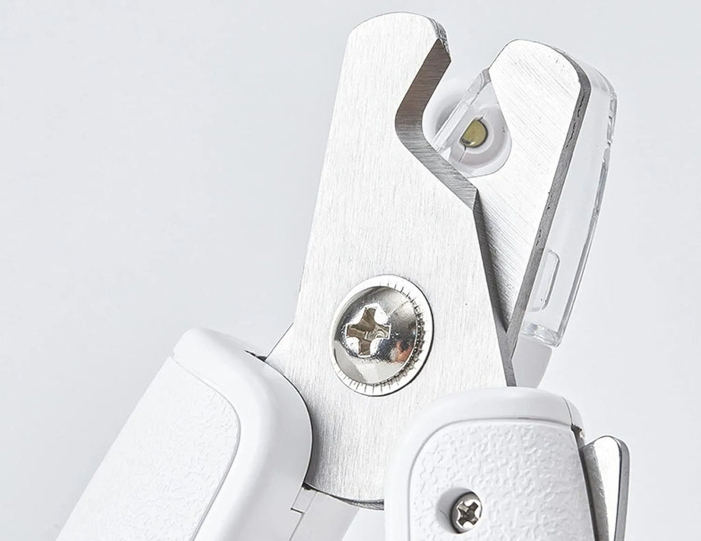 White pet nail clippers with LED light, triangular blade, and transparent anti-splash guard