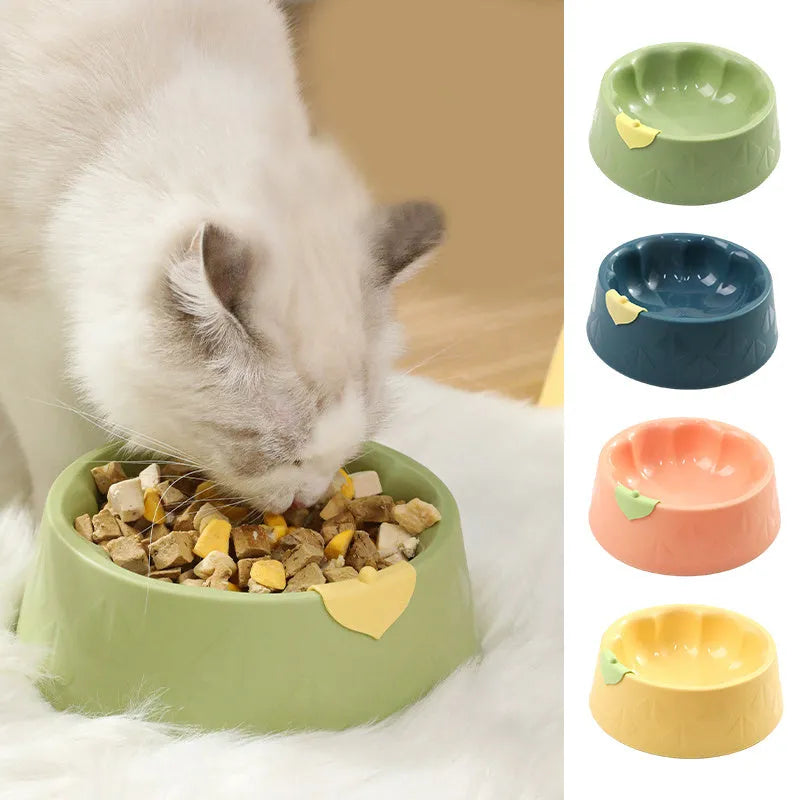 Green and yellow plastic double pet bowl for food and water on a flat surface.