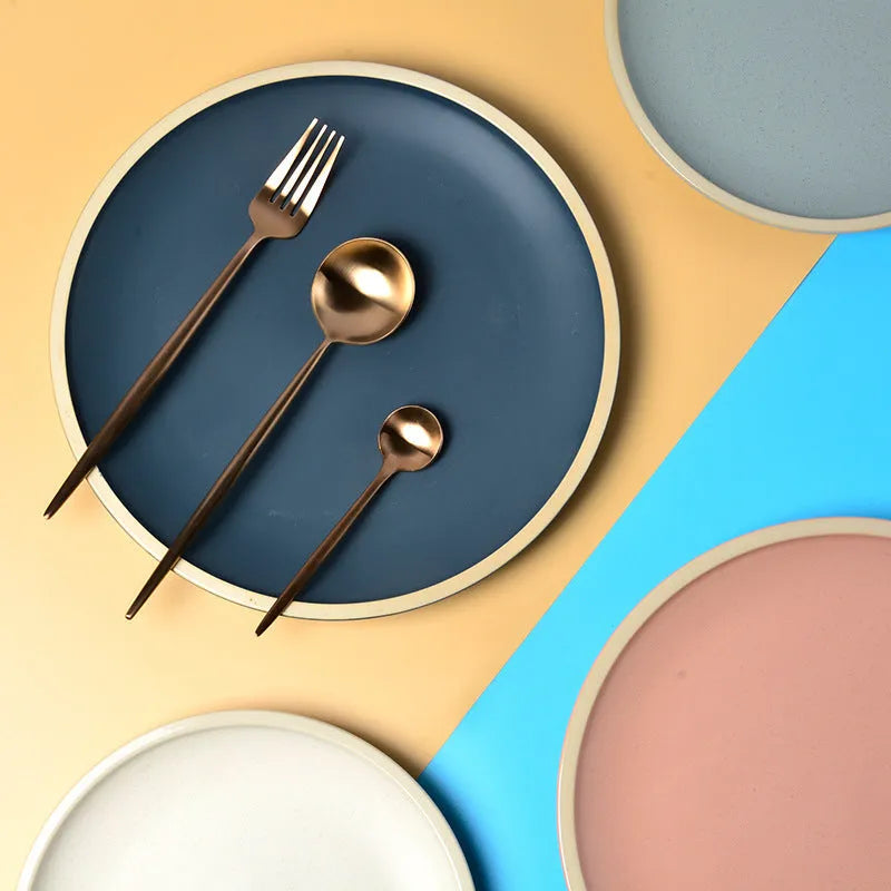Blue matte ceramic plate with sesame point glaze on a table, 10 inch diameter.