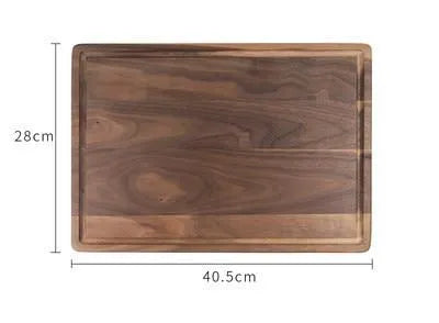 Black walnut wood cutting board with groove edge, rectangular shape, on kitchen counter