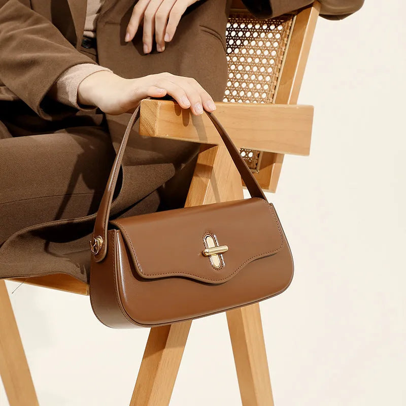 Genuine leather horizontal square baguette bag in black with lock detail