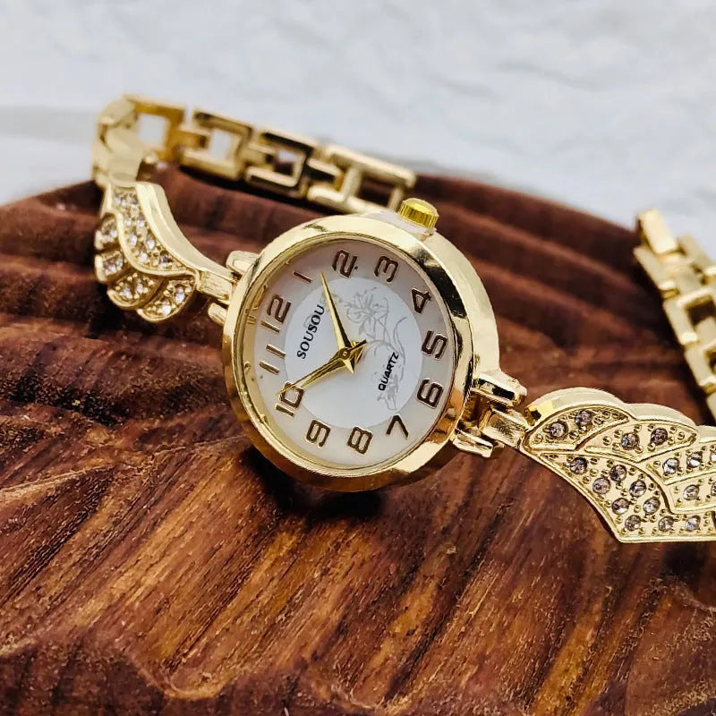 Women's stainless steel watch with round dial on wrist, showing gold surface colour option.