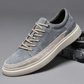 Men's grey low-top casual skate shoes with a pigskin leather upper and rubber sole.