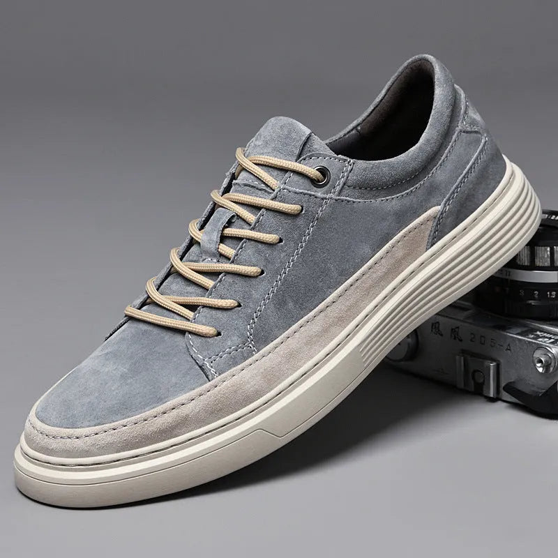 Men's grey low-top casual skate shoes with a pigskin leather upper and rubber sole.
