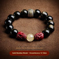 Natural cinnabar bead bracelet with carved animal zodiac design in gold obsidian and silver stone on a silver gift box