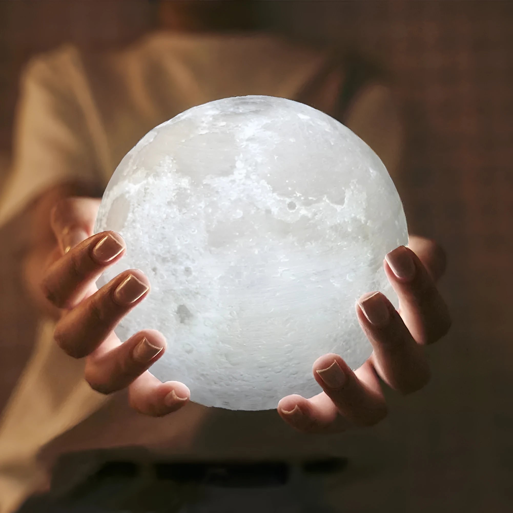 Luna Tranquil Moon Lamp with realistic moon texture and touch colour control on a bedside table