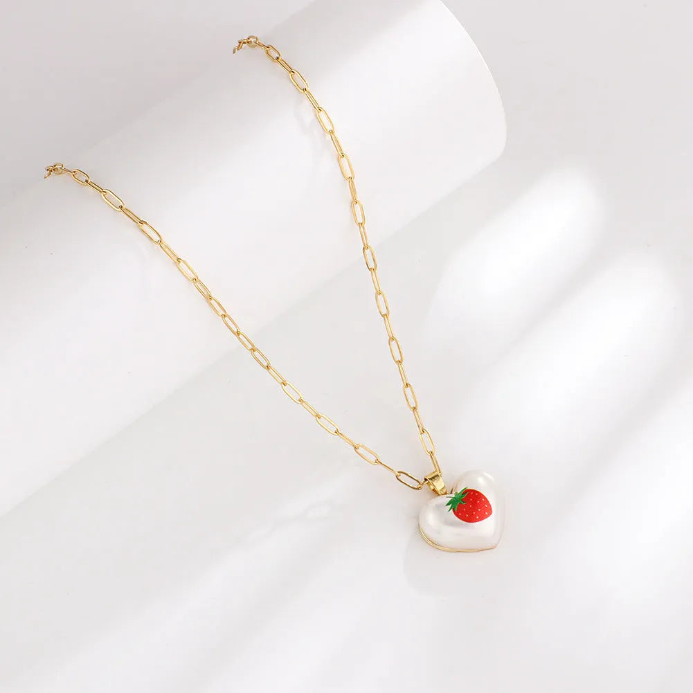 Heart-shaped fruit pendant necklace with strawberry design on adjustable metal chain