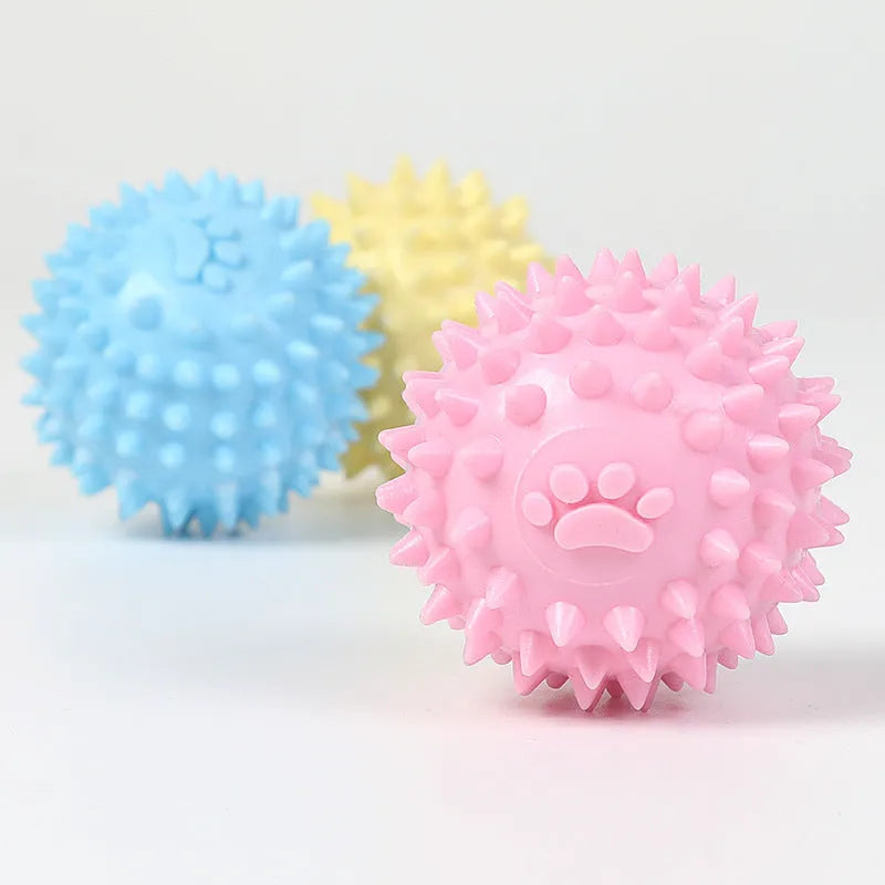 Close-up of 6cm TPR rubber dog chewing toy ball with footprint pattern in blue pink or yellow for tooth cleaning