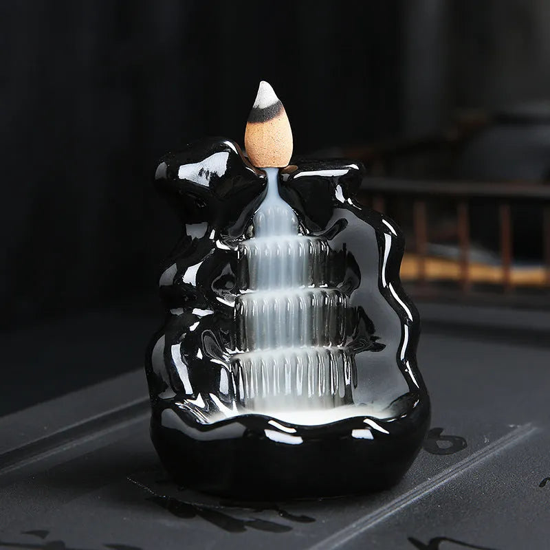 Creative ceramic backflow incense burner ornament in modern simplicity style with smoke cascading downwards