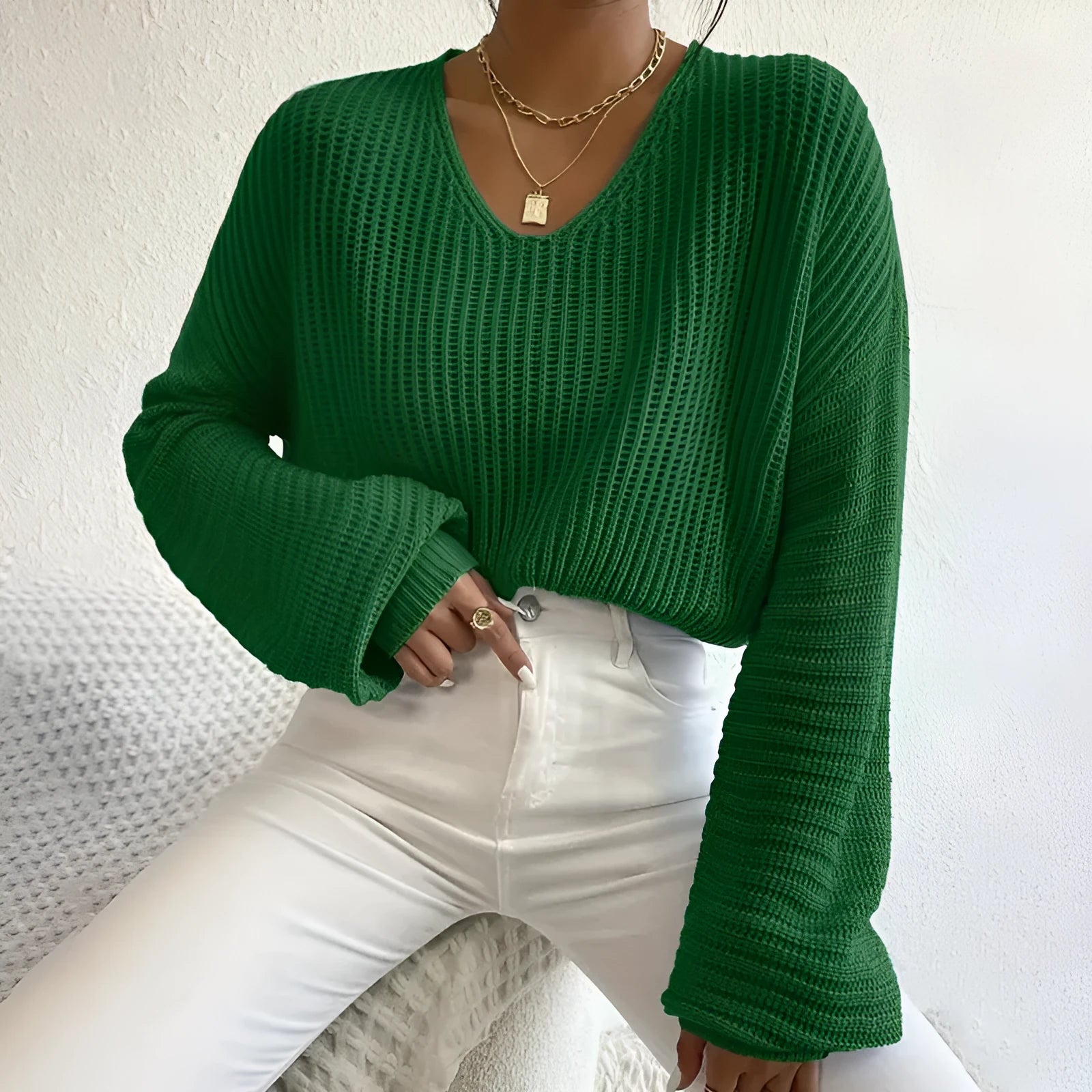Women's solid colour long sleeve pullover in a loose casual fit, shown in one of five colour options.