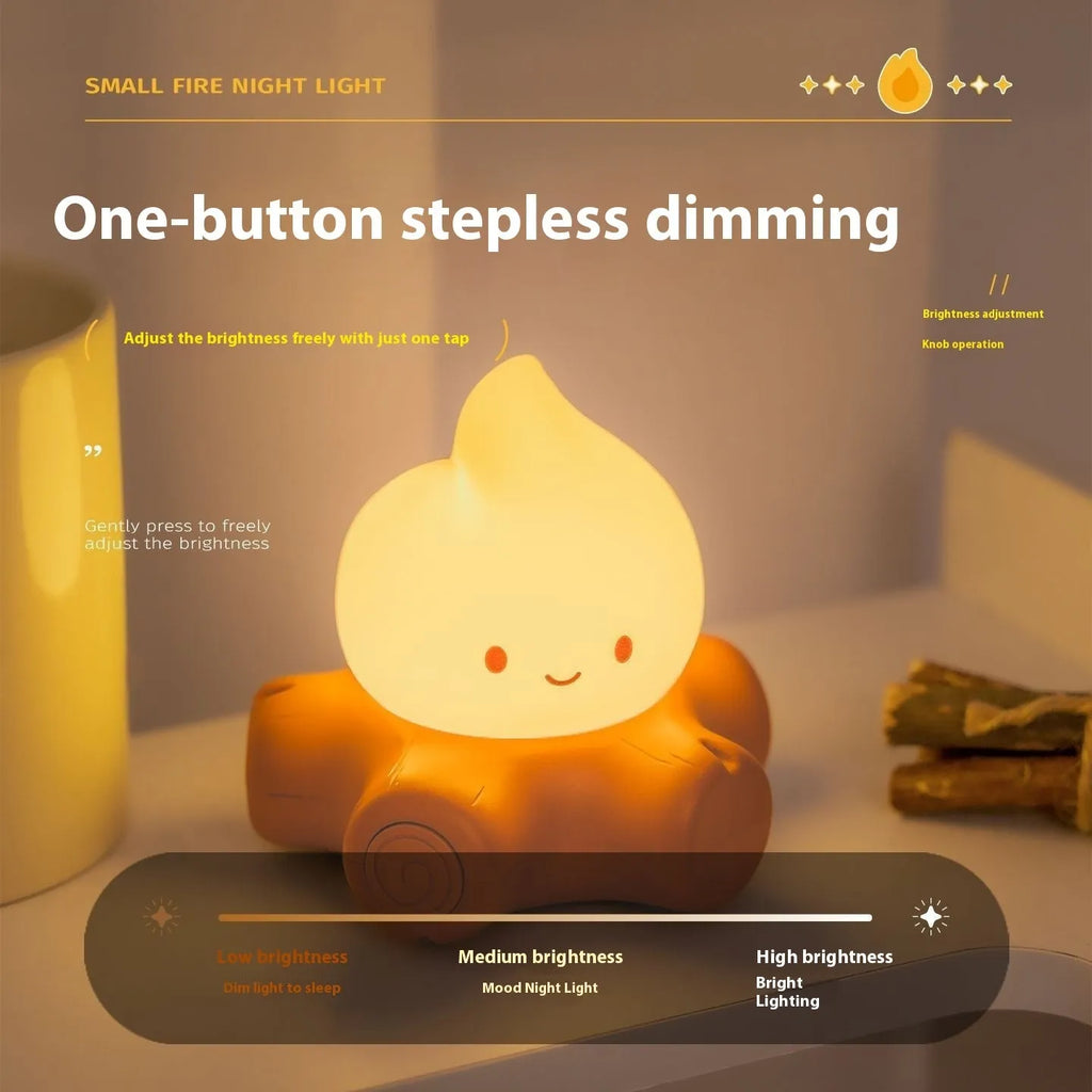 Cartoon-style silicone small fire pile night lamp with yellow glow on a table