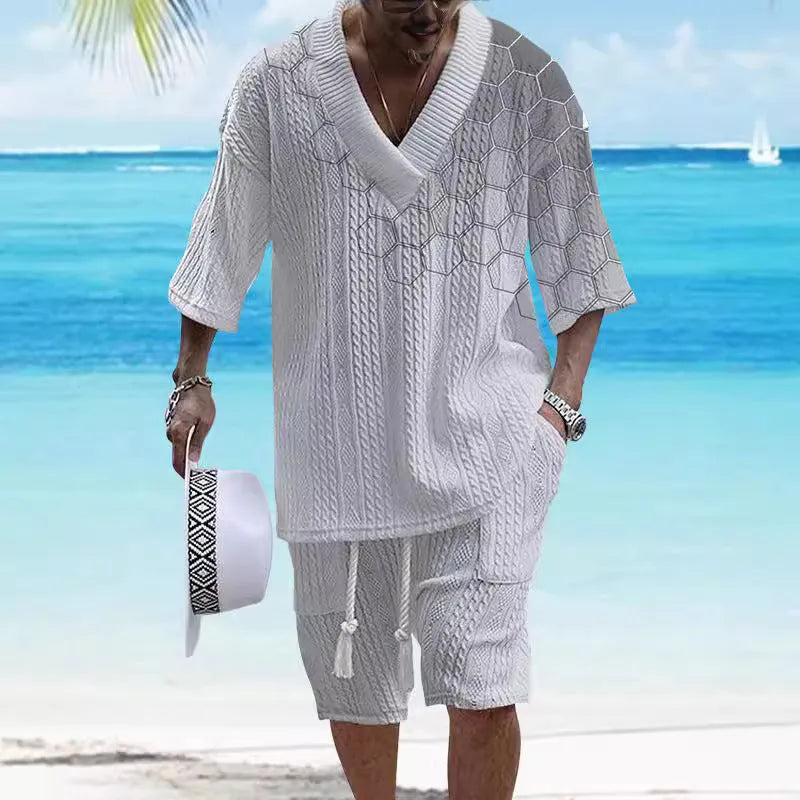 Man wearing a printed drop-shoulder knitted short-sleeved top with matching shorts in a casual setting.