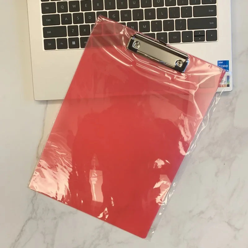 Transparent plastic A4 plate holder with metal clip and integrated writing board surface, shown in blue.