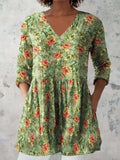 Women's printed loose dress with wide waist and 3/4 length sleeves on a hanger.