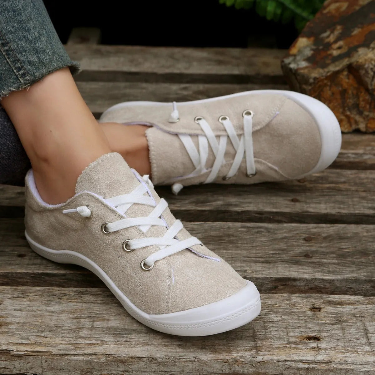 Women's beige casual sneaker with fabric upper and rubber sole on neutral background