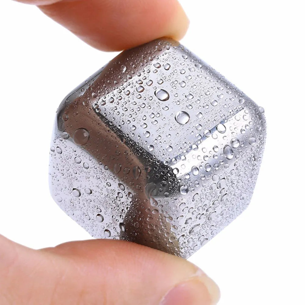 Set of 8 stainless steel ice cubes in square and ball shapes with plastic storage box and tong on a wooden surface