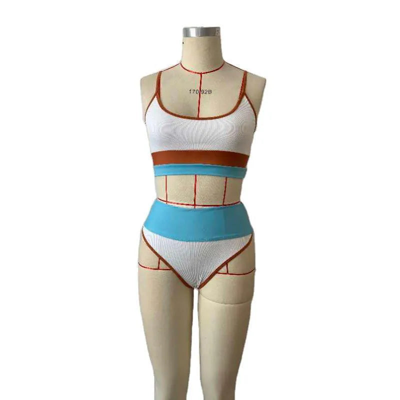 Women's solid colour quick-drying swim top and nylon shorts set on a mannequin.