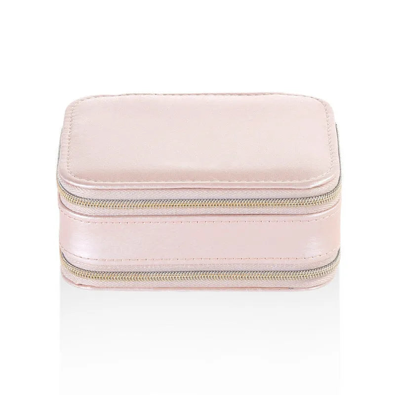 Small PU zipper jewellery box in light blue with fabric lining, 11.5x8.5x5cm, open to show rings and earrings