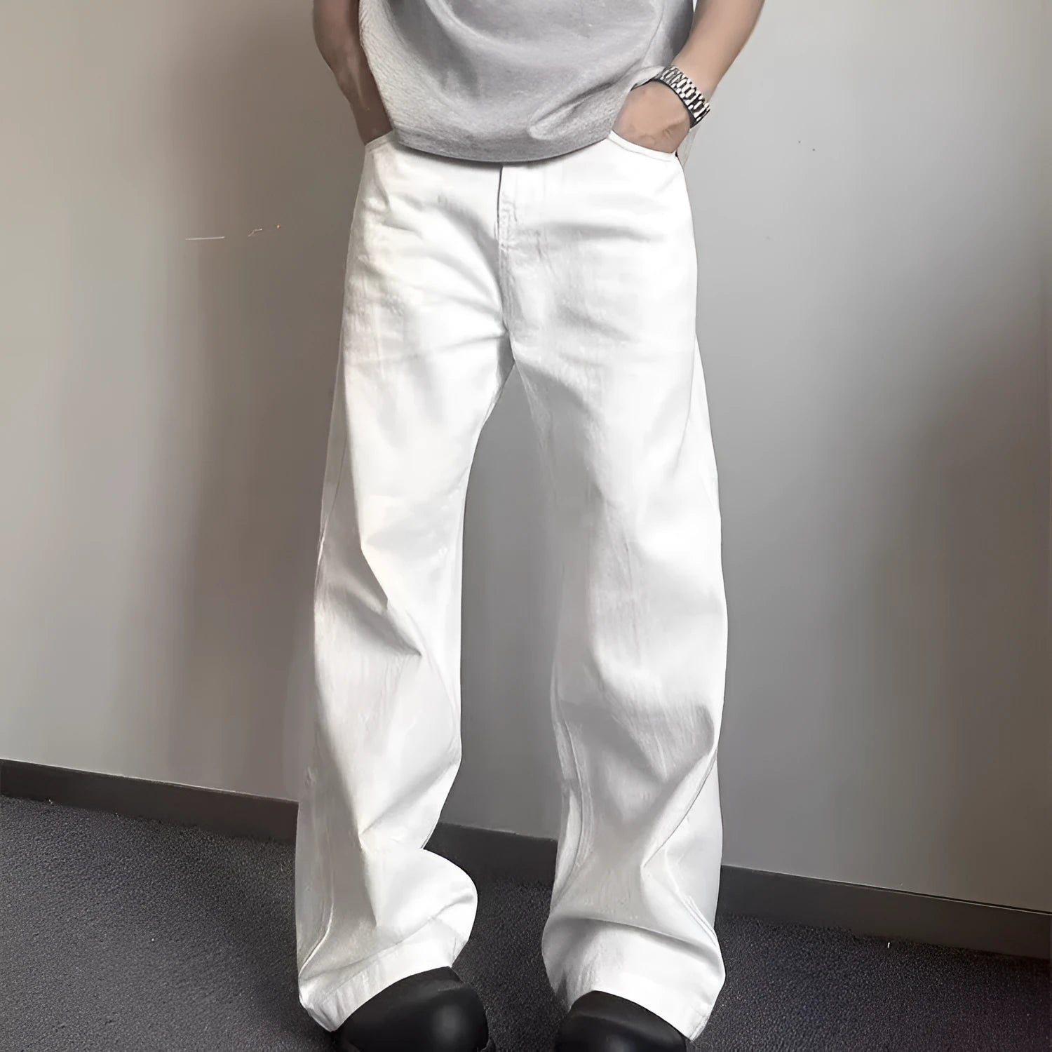 Men's white loose fit straight-leg cotton denim jeans on a plain background.