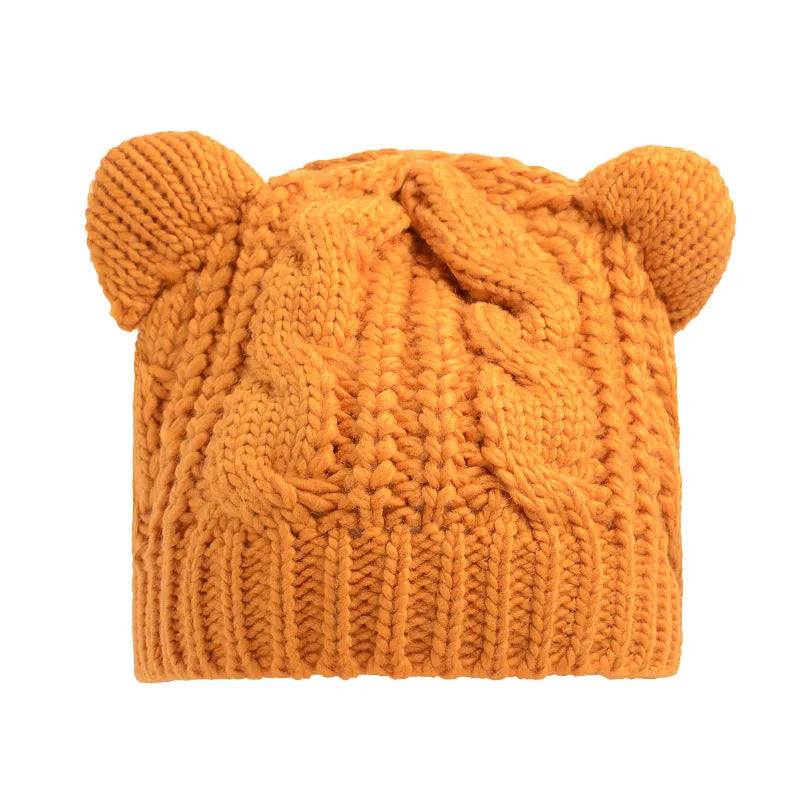 Red handmade knitted wool beanie hat with 3D cat ears on a white background
