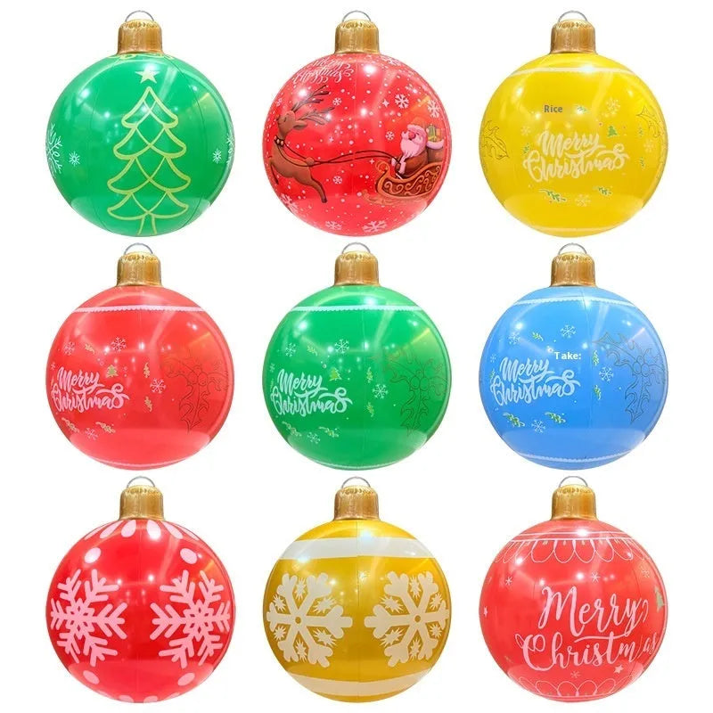 Large red inflatable Christmas ball with flash LED lights in a snowy garden.
