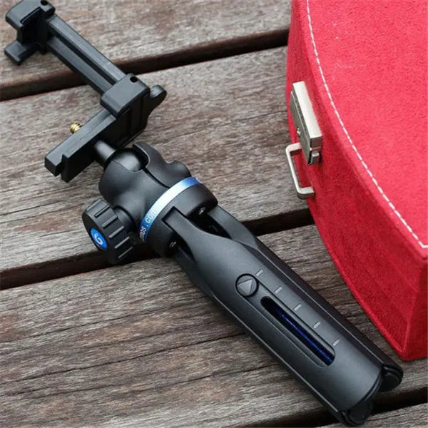 Black desktop phone tripod stand compatible with iPhone models on a desk
