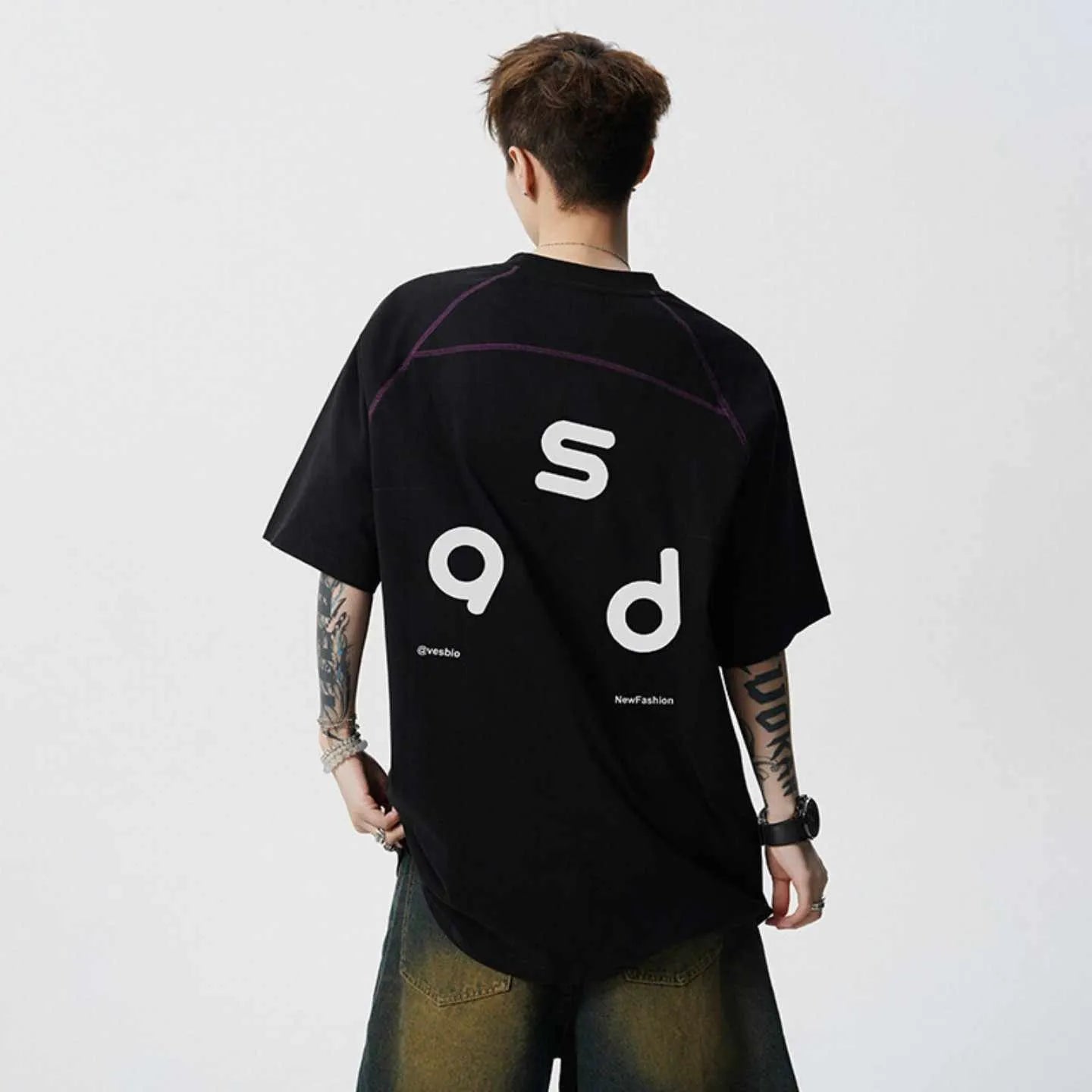 Man wearing a black loose-fit cotton short-sleeve T-shirt with a round neck collar.