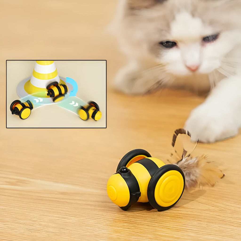 Electric cat car toy in pink with feather teaser stick, moving randomly on a carpet
