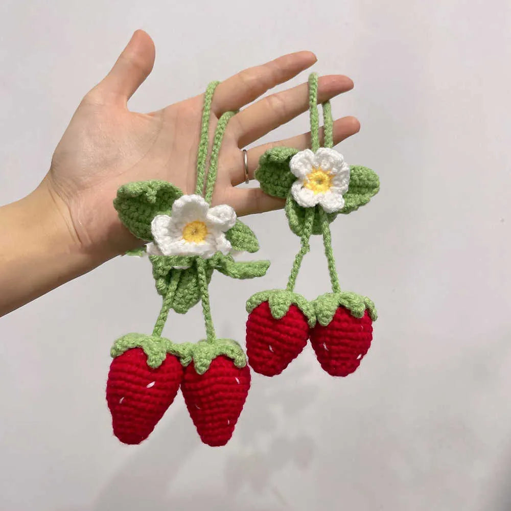 Handmade strawberry-shaped car weaving pendant made from cotton and hemp fibres.