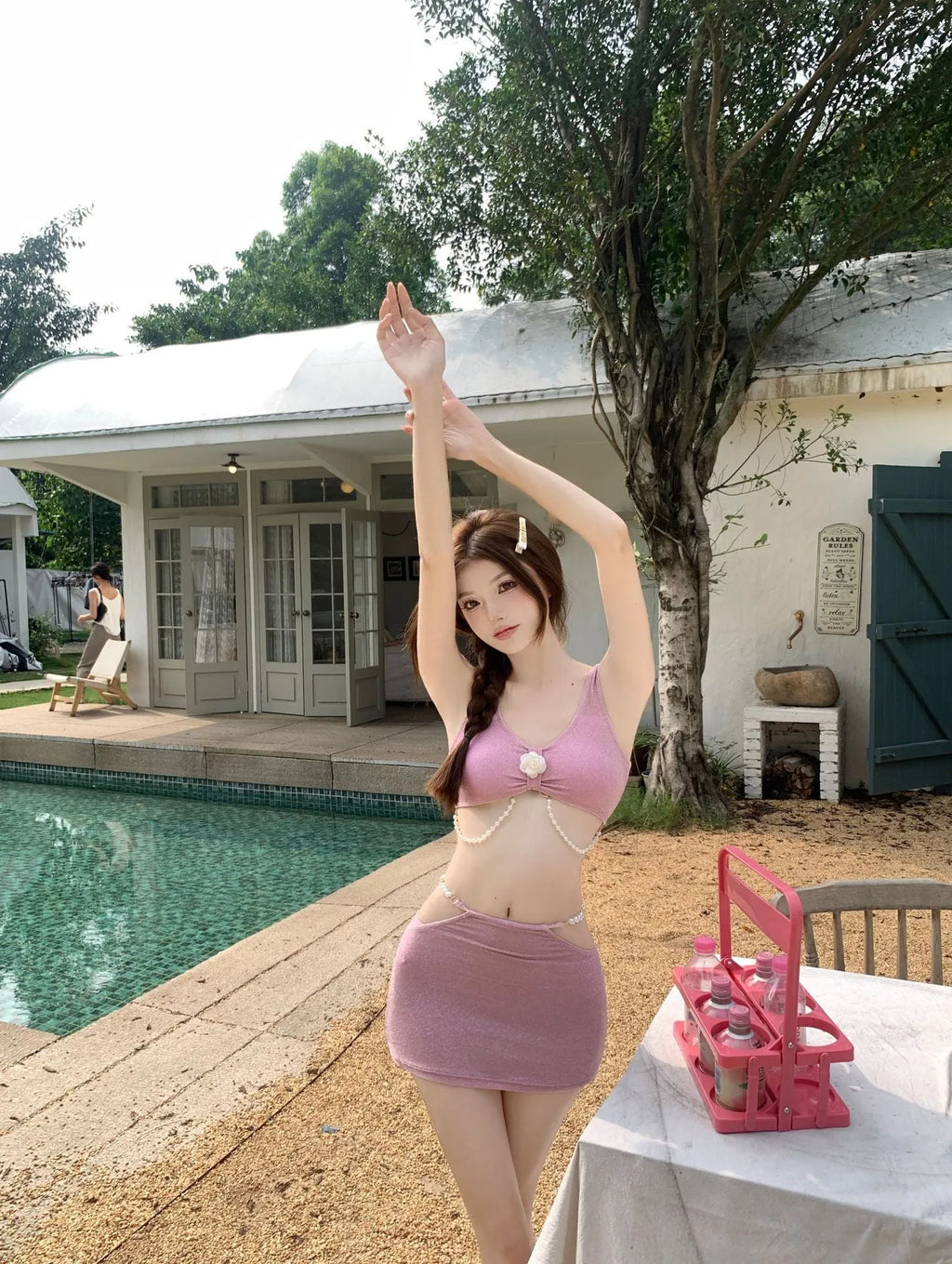 Women's pink and black three-piece polyester bikini swimsuit for swimming.