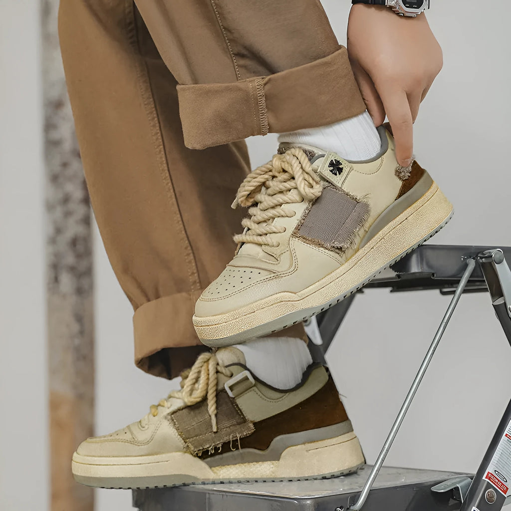 Beige low top skateboard shoes with rubber sole and front lace-up design