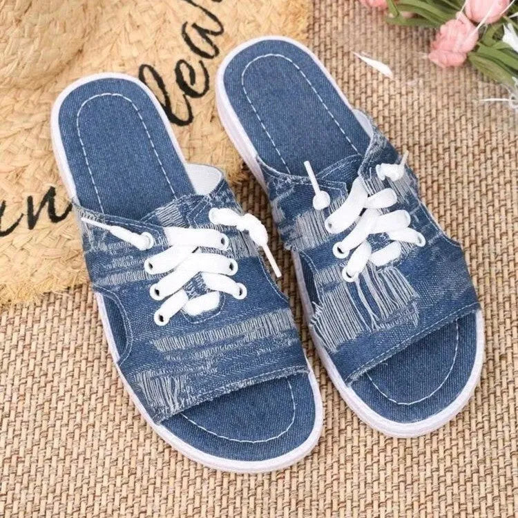 Blue women's canvas slippers in Roman style with a flat design and rubber sole