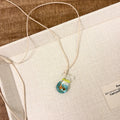 Women's necklace with a coloured glaze Joker pendant wearing a skirt on a cotton and linen chain.