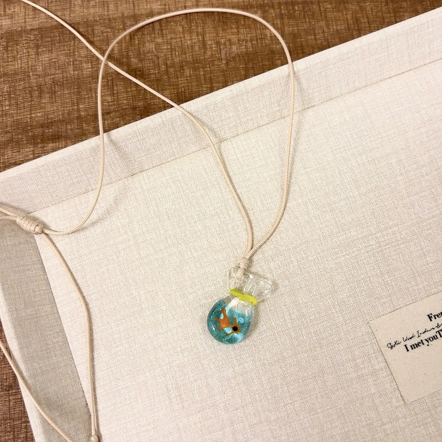 Women's necklace with a coloured glaze Joker pendant wearing a skirt on a cotton and linen chain.