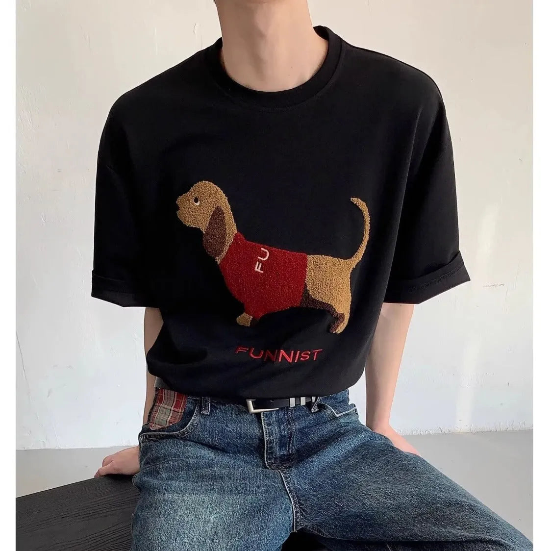 Grey men's cotton t-shirt with embroidered dachshund dog holding a towel graphic.