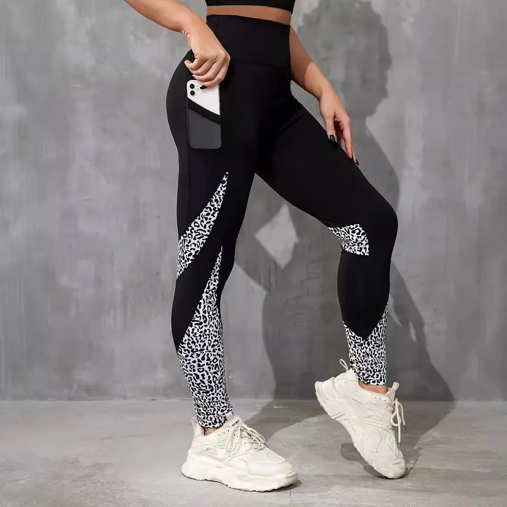 Woman wearing black ribbon letters colour contrast patchwork high waist yoga leggings with pocket