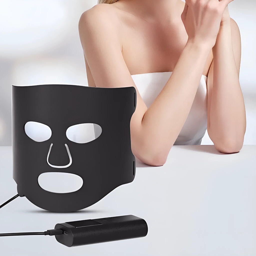 Black and gold LED light therapy face mask with multiple coloured lights for skin treatment