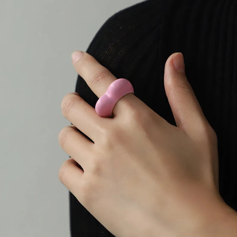Three-dimensional heart-shaped enamel ring in multiple colours on a zinc alloy band.