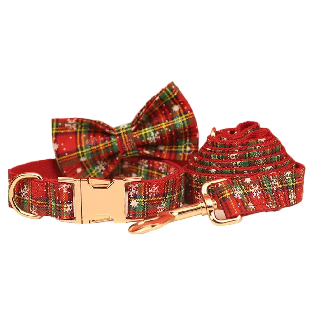 Red background snowflake plaid Christmas pet collar leash set with bowknot flowers and dog vest on a small dog