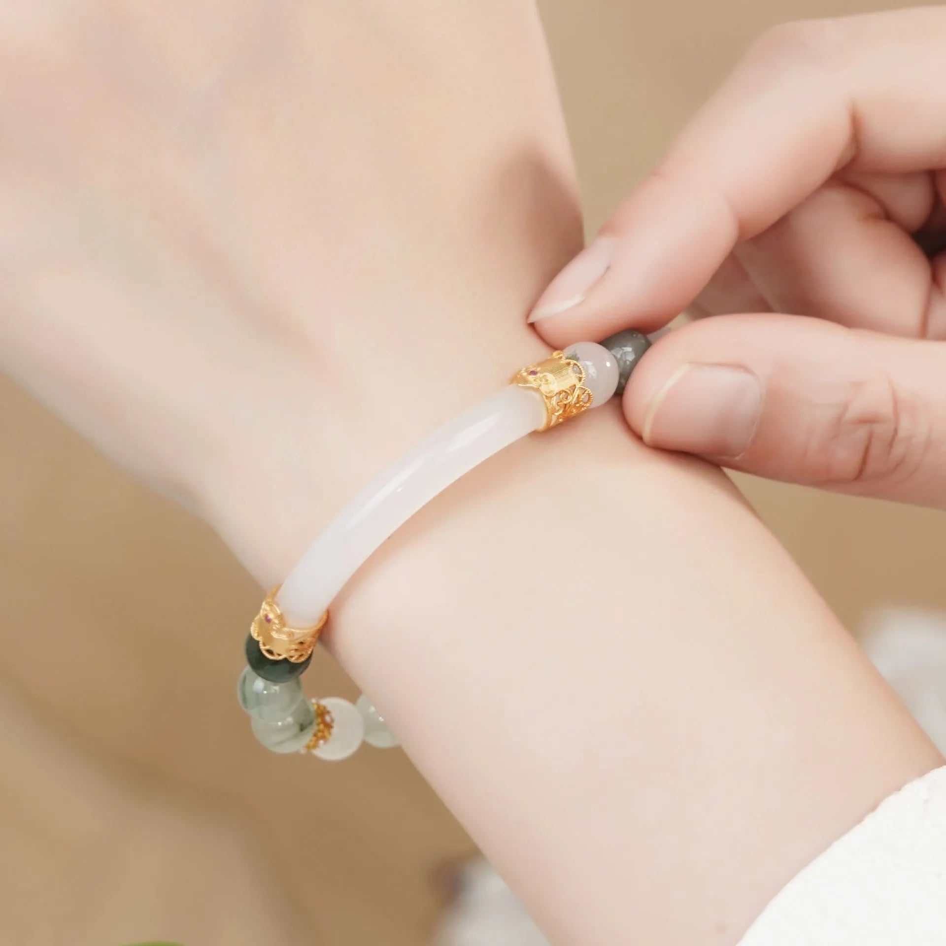 Emerald green Tian Shan Cui half bracelet with floating flower girl design and round motif on light background