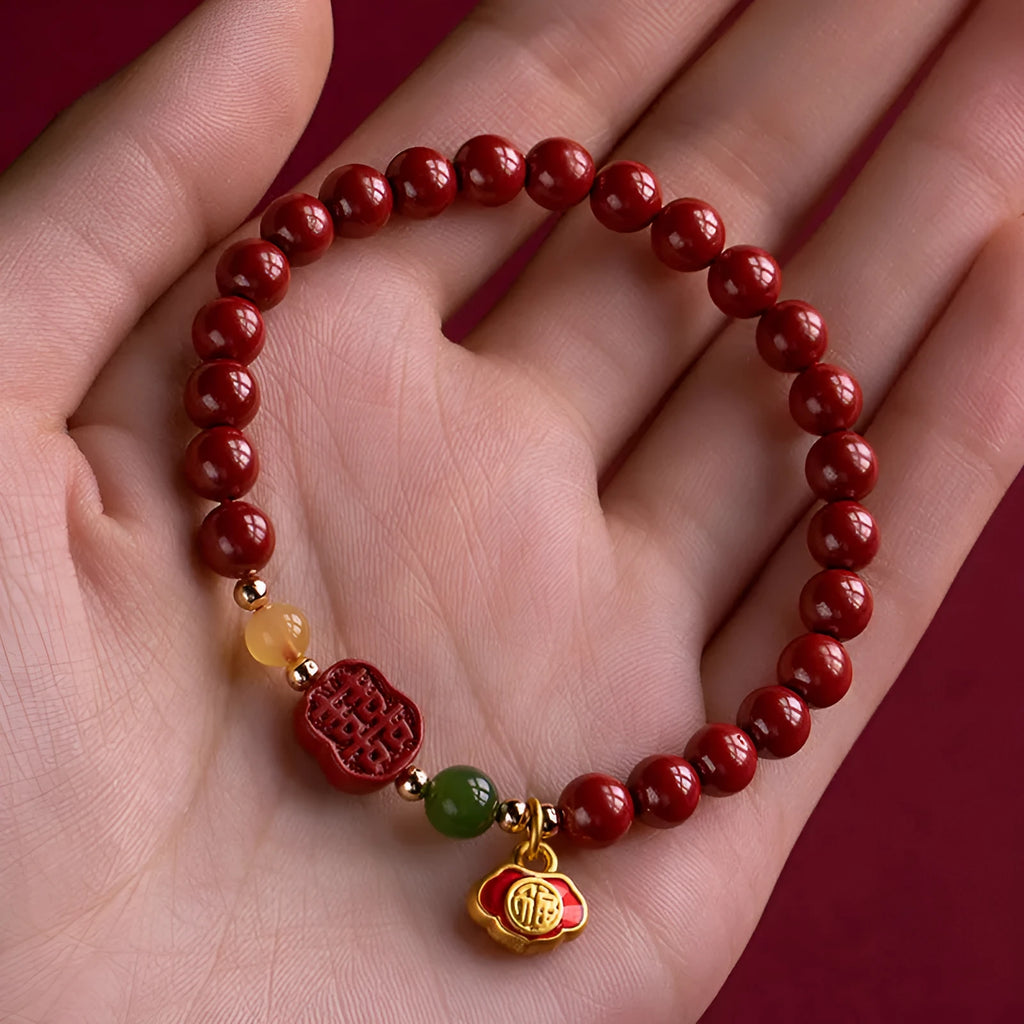 Happy eyebrow bracelet with emperor sandstone beads and a central carved fu charm on a string.