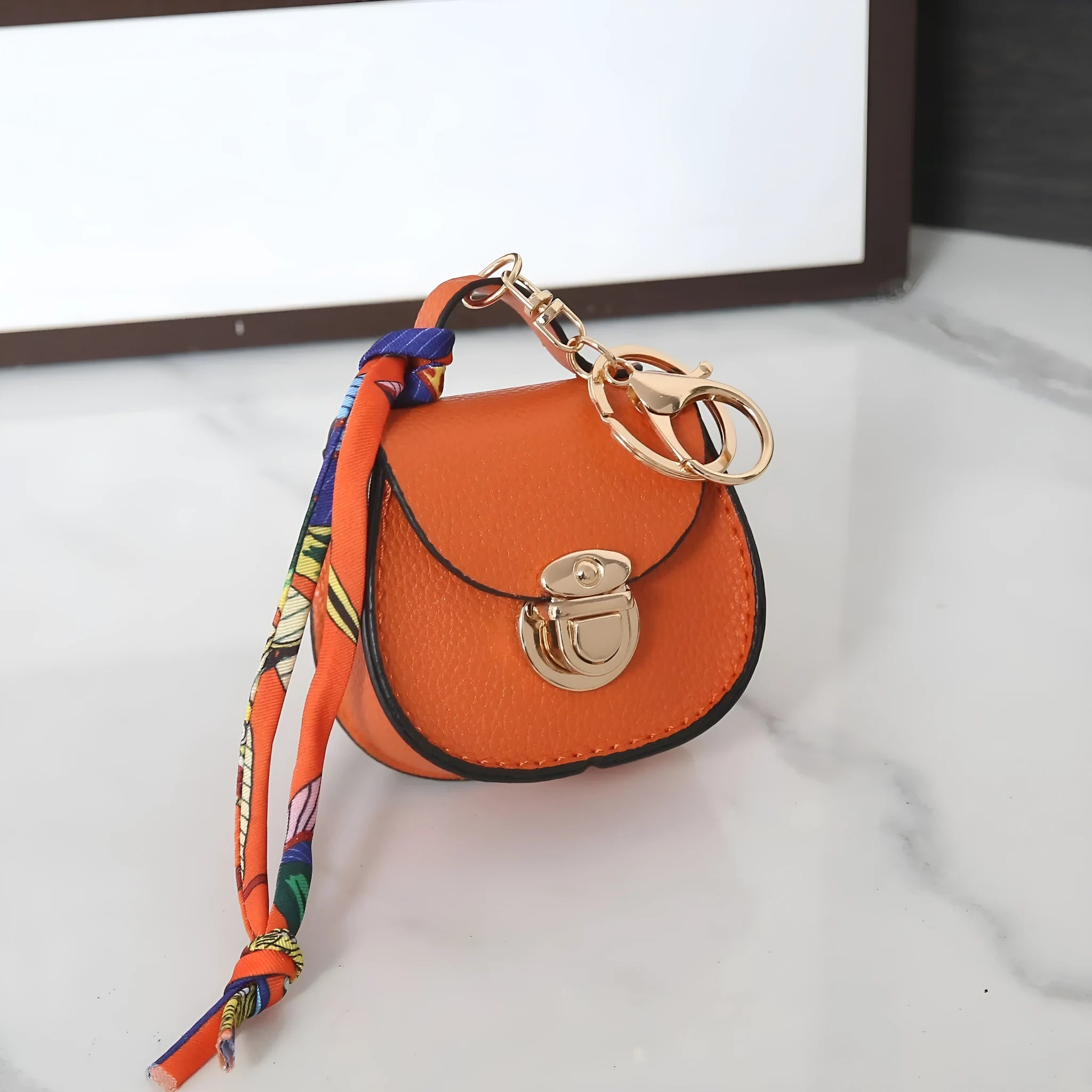 Small PVC coin purse pendant in solid colour with keychain attachment on white background