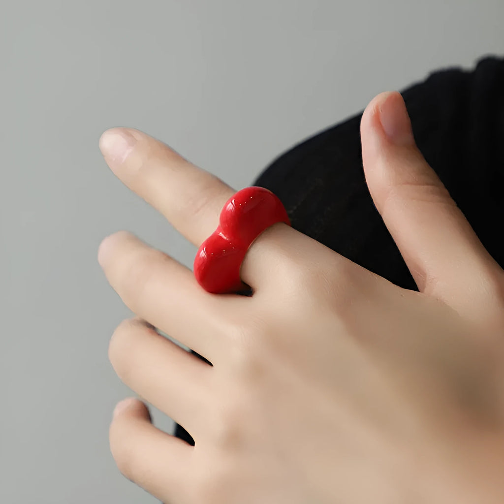 Three-dimensional heart-shaped enamel ring in multiple colours on a zinc alloy band.